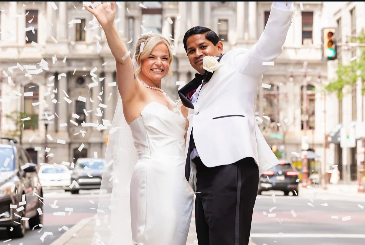Happy newlyweds celebrating with confetti
